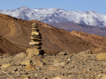 Stack of rocks on mountain against sky