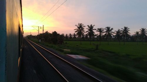 Panoramic view of railroad tracks against sky during sunset