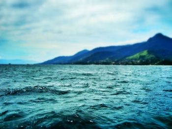 Scenic view of sea against cloudy sky