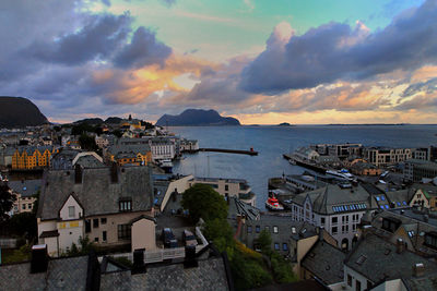 High angle view of townscape by sea against sky