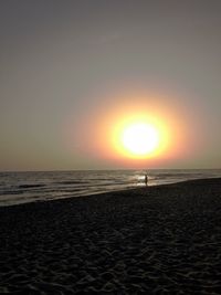 Scenic view of sea against clear sky during sunset