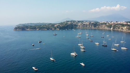 High angle view of sailboats in sea against sky