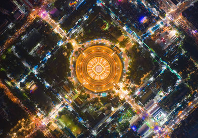 Aerial view of illuminated temple in city at night