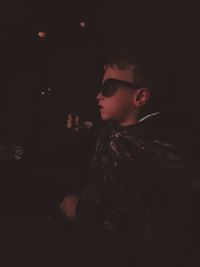 Portrait of young man looking away at night