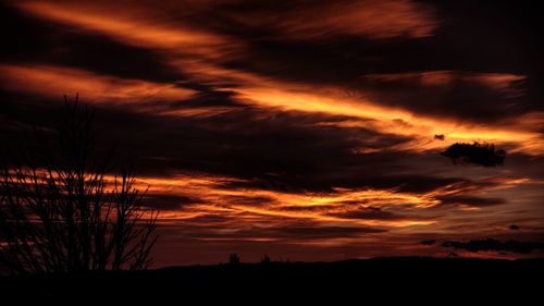 Silhouette of landscape against cloudy sky