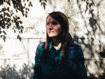 Portrait of woman standing on wall