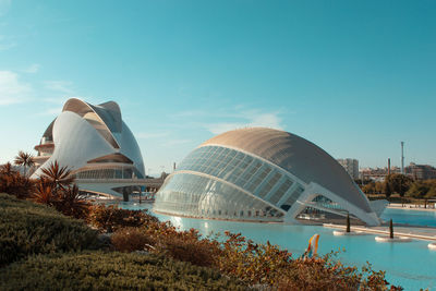 Buildings in city against blue sky