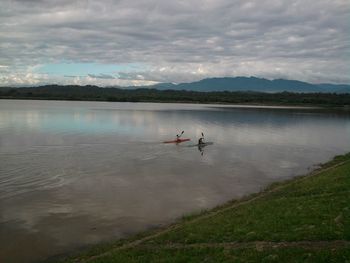 Scenic view of lake against cloudy sky