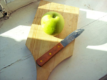 High angle view of apples on cutting board
