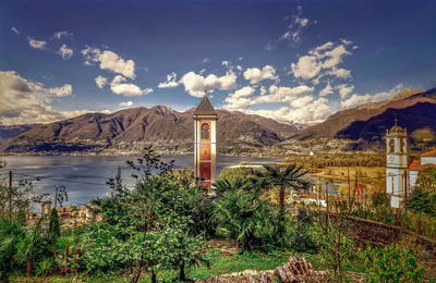 Scenic view of building by mountains against sky