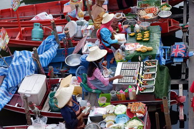 High angle view of people for sale at market stall