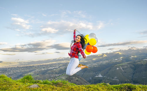 Full length of woman standing on mountain landscape