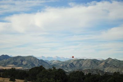 Scenic view of mountains against cloudy sky