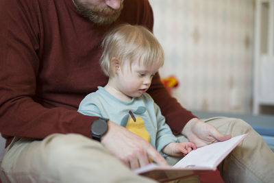 Close-up of boy playing with toy at home