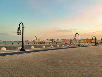 View of street against sky during sunset