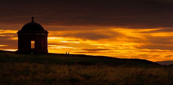 Silhouette of temple against sky during sunset