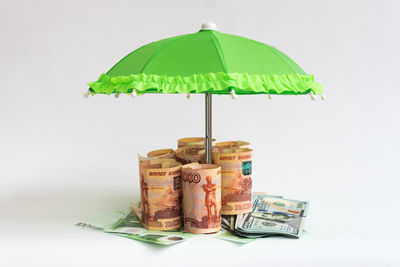 Close-up of coins on table against white background