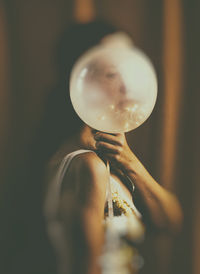 Woman behind an illuminated balloon iii