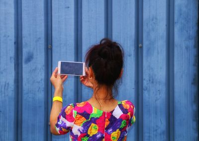 Rear view of woman using mobile phone