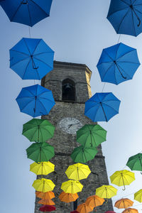 Low angle view of umbrellas against building