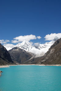 Scenic view of snowcapped mountains against blue sky