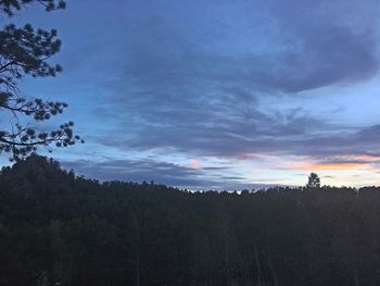 Scenic view of silhouette forest against sky at sunset