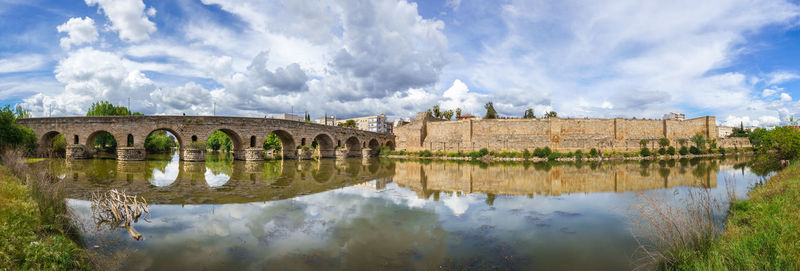 Panoramic view of bridge over river against buildings