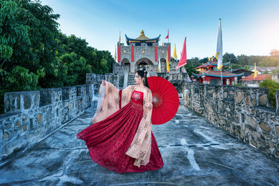 Rear view of woman standing against temple