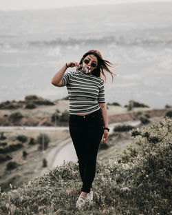 Full length of woman standing on rock