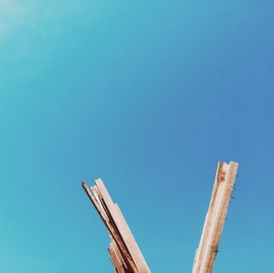 Low angle view of windmill against clear blue sky