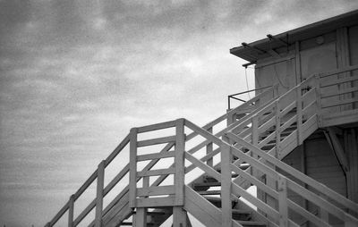 Low angle view of staircase against cloudy sky