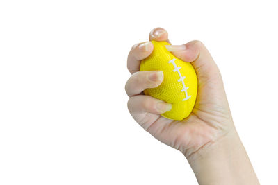 Hand holding yellow over white background