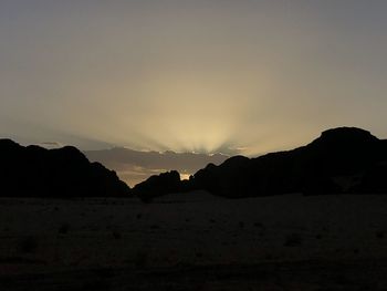 Scenic view of silhouette mountains against sky at sunset