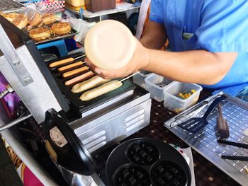 Midsection of man preparing food in kitchen