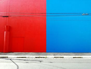 Red and blue wall by street