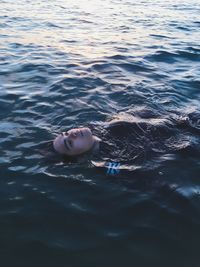 High angle portrait of boy swimming in pool