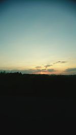 Silhouette landscape against clear sky during sunset