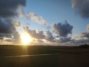 Scenic view of field against sky during sunset