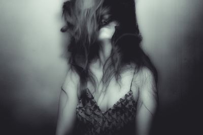 Close-up of woman standing against white background