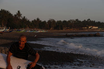 Portrait of man sitting on beach