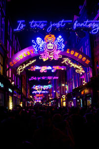 Group of people in illuminated building at night