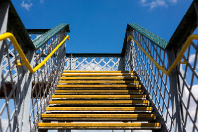 Low angle view of yellow staircase against sky