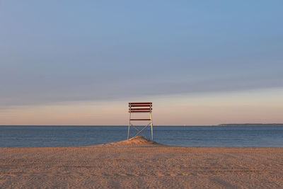 Lifeguard hut on beach against sky