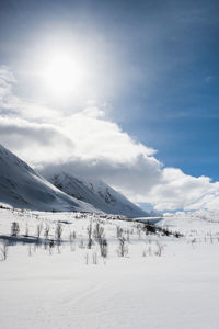 Scenic view of snow covered mountains against sky