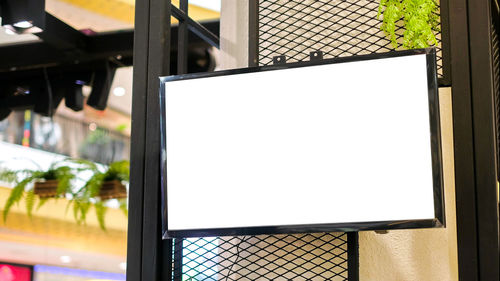 Close-up of illuminated lighting equipment on street against building