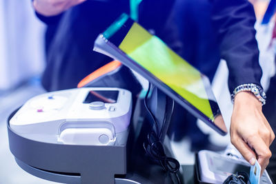 Midsection of man using smart phone