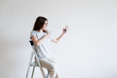 Woman looking at camera against white background