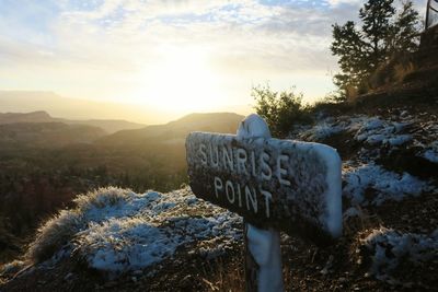 Close-up of snow on landscape against sky