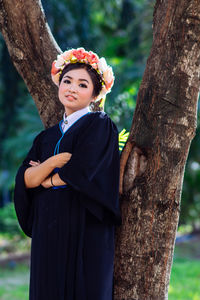 Portrait of smiling young woman in forest