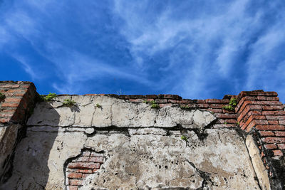 Low angle view of old building against blue sky